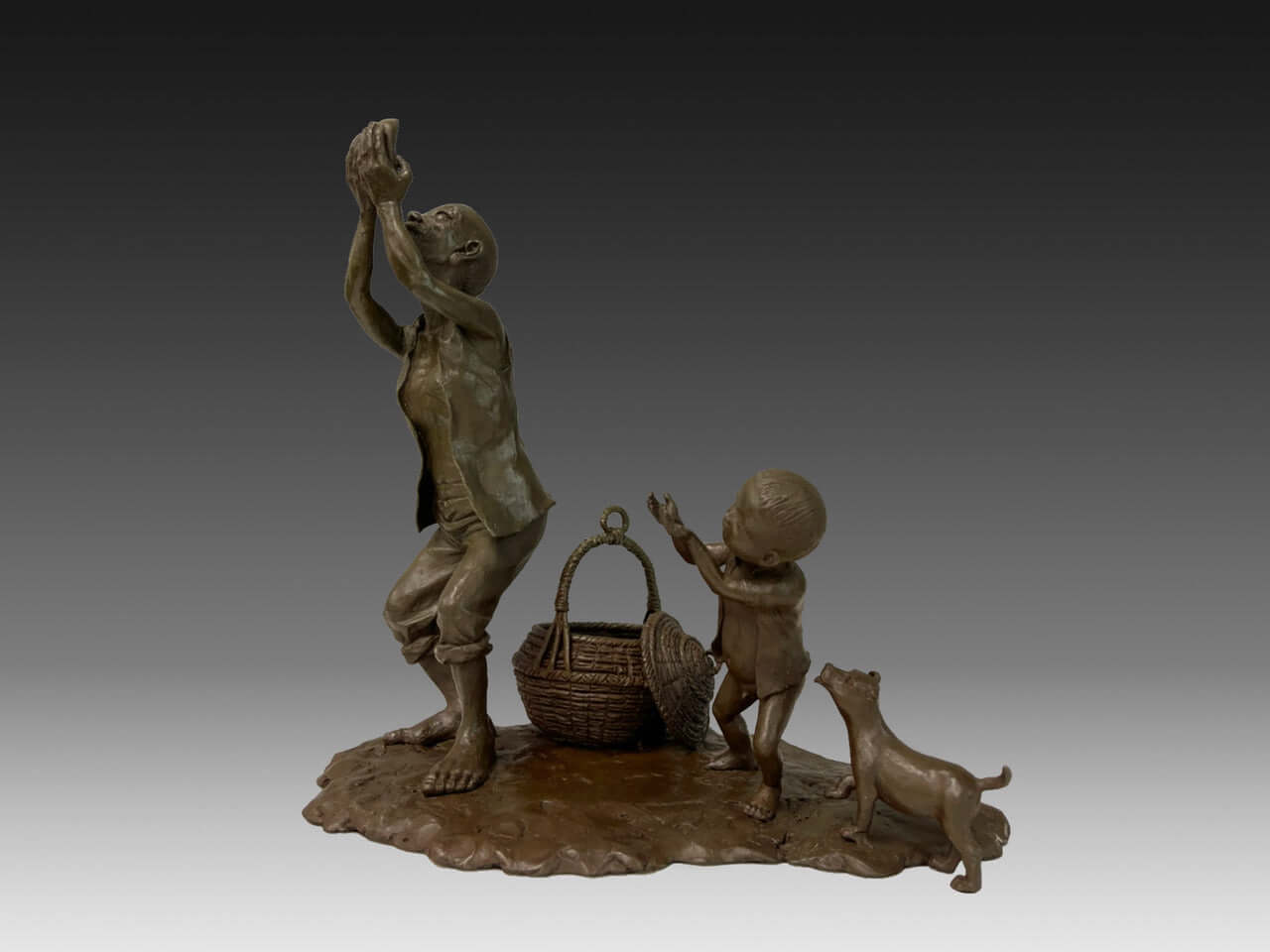 Bronze sculpture of a grandfather and grandson in rural Taiwan, depicting a tender prayer moment with a dog nearby.