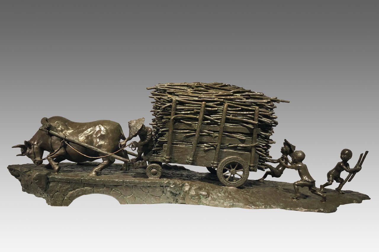 Bronze sculpture of an ox cart piled with sugarcane, traditional rural scene with kids sneakily enjoying sugarcane.